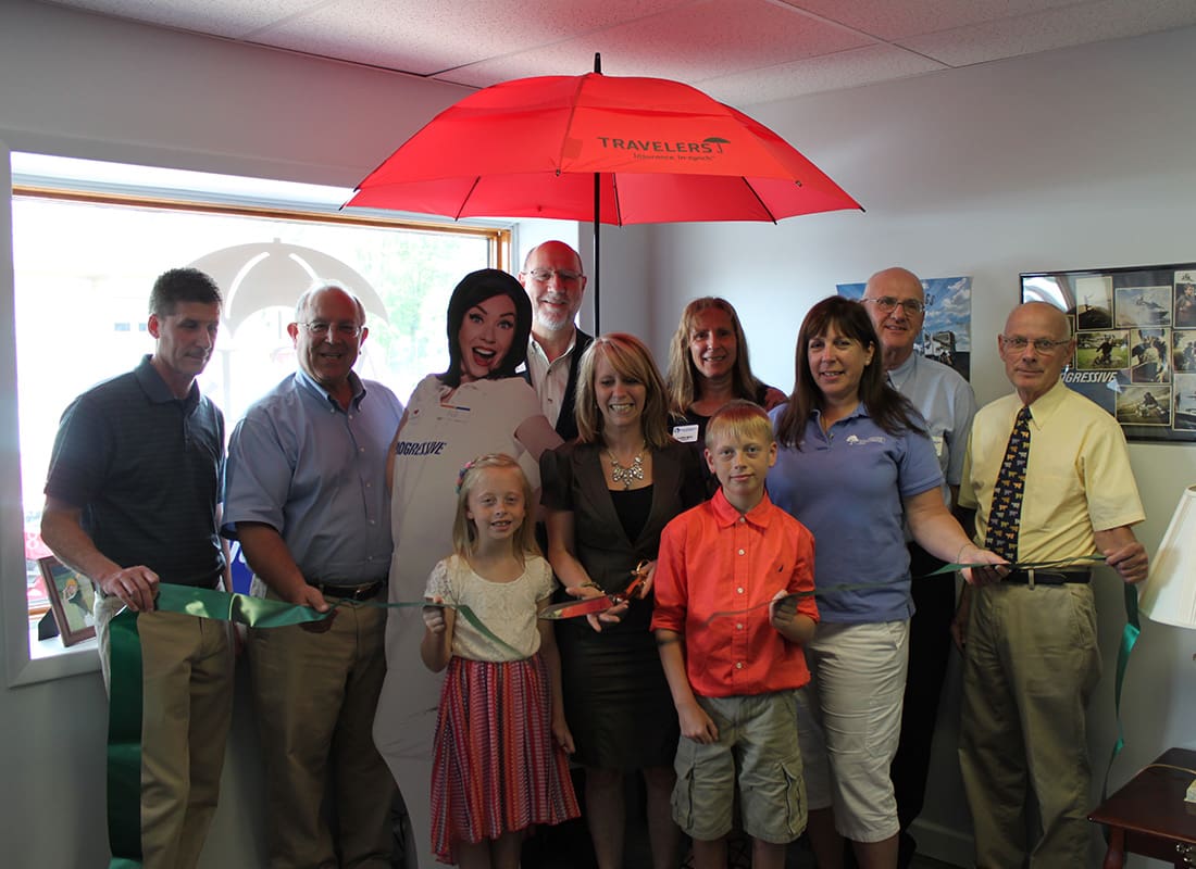 We Are Independent - ASK Insurance Team and Family Standing Together Inside Their Office